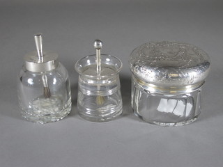 An Art Deco glass and silver mounted dressing table jar fitted a brush, Birmingham 1902, a similar and a circular glass  Continental dressing table jar with embossed white metal lid
