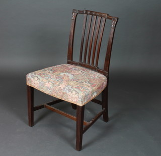 A 19th Century mahogany stick and rail back dining chair with upholstered seat on square tapering supports with H framed  stretcher