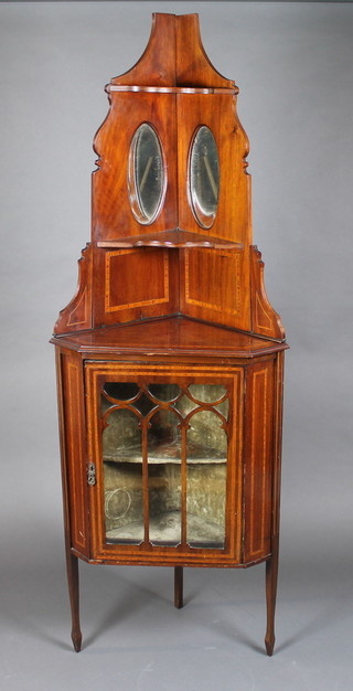 An Edwardian inlaid mahogany corner cabinet, the upper section  with niche, the base fitted a cupboard enclosed by astragal glazed  panelled doors 25"w x 16"d x 73"h