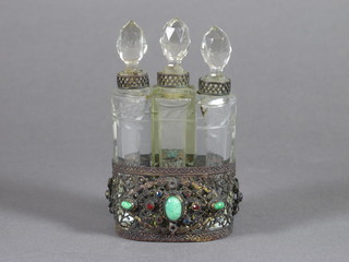 3 cut glass scent bottles contained in an oval pierced gilt metal frame 2 1/2"