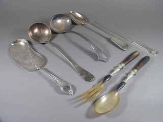 A silver plated crumb scoop, 2 silver plated ladles, a silver plated serving spoon, do. skimmer and a pair of horn salad servers