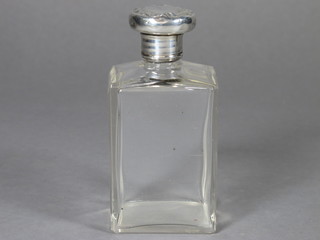 A rectangular glass bottle with silver lid