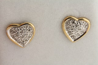 A pair of 9ct gold heart shaped earrings set diamonds