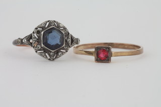A lady's 9ct gold dress ring set a red stone and 1 other dress ring