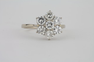 A lady's white gold cluster dress ring set 7 diamonds