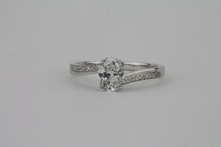 A lady's 18ct white gold engagement/dress ring set an oval  solitaire diamond and with diamonds to the shoulders,  approx. 0.80ct