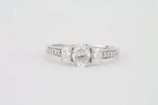 A lady's 18ct white gold engagement/dress ring set 3 diamonds  and with diamonds to the shoulders