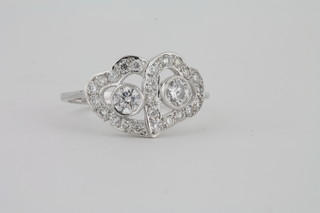 A lady's 18ct white gold dress ring in the form of double hearts  set diamonds, approx 0.90ct