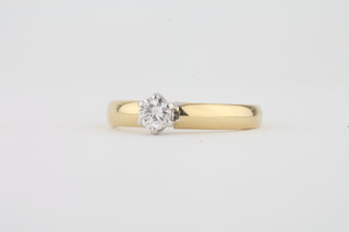A lady's 18ct gold dress ring set a solitaire diamond