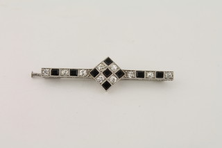 An Art Deco white gold bar brooch set diamonds and black  stones