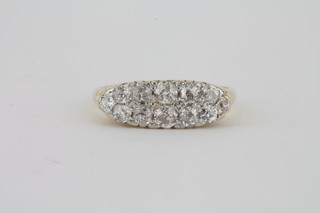 A lady's 18ct gold and platinum half hoop ring set 12 diamonds