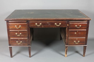 An Edwardian mahogany kneehole pedestal desk with inset green leather writing surface above 1 long drawer, the pedestal fitted  brushing slides and 6 drawers, raised on square tapering supports  59"w x 35"d x 30"h