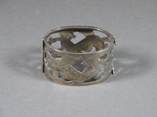 A pierced silver bangle decorated dolphins