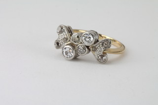 A lady's 18ct gold dress ring set diamonds, supported by a heart shaped panel set 6 diamonds