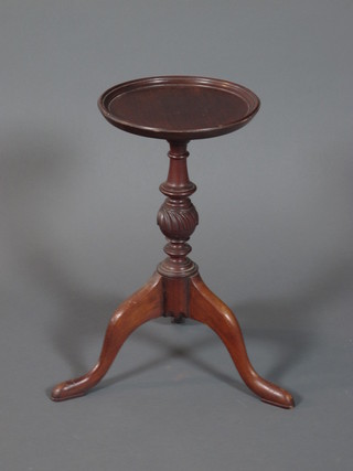 A Victorian mahogany kettle stand with moulded dish top on a spiral carved turned column support, tripod base