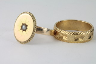 A gold dress ring set an oval panelled demi-pearl together with a  gilt metal dress ring