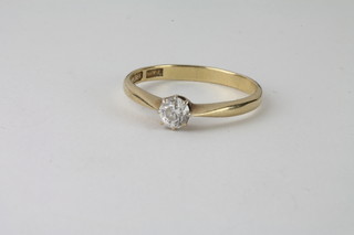 An 18ct gold dress ring set a solitaire diamond