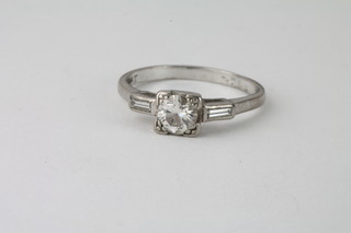 A lady's 18ct white gold or platinum dress ring set a circular  diamond with 2 baguette cut diamonds to the shoulders