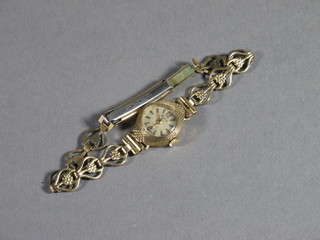 A lady's Accurist wristwatch contained in a gold case and with gilt metal bracelet