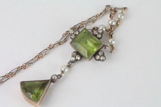 A lady's Edwardian chain hung a rectangular peridot and  pyramid shaped pendant interspaced demi-pearls