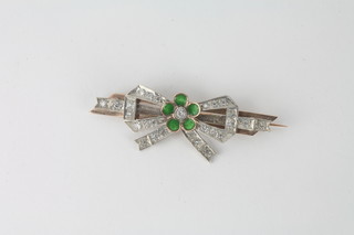 A Soviet Russian brooch marked 500 875 in the form of a bow  set diamonds and green enamelled petals to the centre
