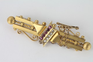 A 15ct gold bar brooch set diamonds and red stones