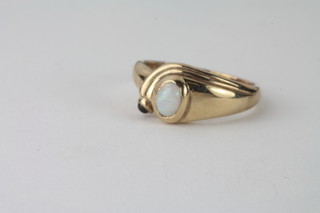 A 9 ct gold dress ring a set cabouchon cut "opal"