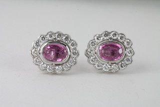 A pair of gold earrings set oval cut pink sapphires surrounded by surrounded by diamonds approx 1.90ct/1ct
