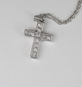 A white gold cross set diamonds hung on a fine gold chain,  approx 0.65ct
