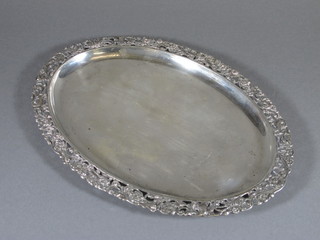 A 19th Century Dutch silver serving dish of oval form, the rim pierced and cast with foliate scrolls and exotic birds, 17 ozs