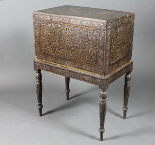 An early 19th Century black lacquered box on stand, heightened  in gilt and decorated panels and bands of arabesques, song birds  and scrolling foliage, the hinged top decorated to interior centred  with exotic birds within foliate reserves, raised on turned tapered  illusionist fluted legs, peg feet 36"h x 26" x 17.5"d   ILLUSTRATED
