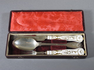 A silver and porcelain handled christening set comprising George  III silver fiddle, thread and shell patterned spoon, London 1799  together with 2 William IV silver bladed and porcelain  handled knife and fork London 1835, cased