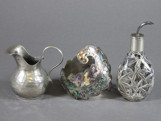 A planished metal jug 2", a waisted glass bitters jar with Oriental  pierced white metal mounts 3" and a silver and shell bracelet