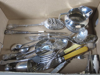 A silver plated cream jug and a collection of flatware etc