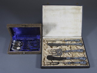A Continental silver handled bread fork, 2 forks and 2 knives, cased, together with a set of 6 Continental spoons, cased