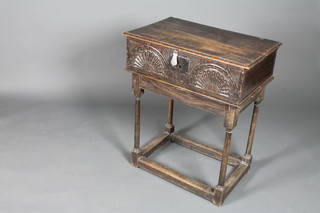An early 18th Century oak bible box on stand, having a moulded  hinged top, the interior later fitted for cutlery, the front carved  with lunettes and centred with a monogramme I G, raised on a  later oak stand 33"h x 28"w x 18"d