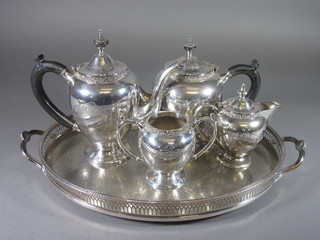 An engraved silver plated 4 piece tea service comprising teapot,  hotwater jug and sugar bowl and a twin handled tray