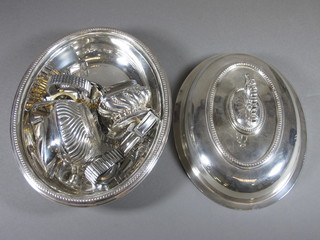 An oval silver plated entree dish and cover 10" containing a  silver plated cream jug and other plated items etc