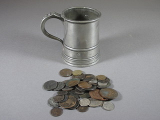 An 18th Century pewter tankard containing a collection of coins