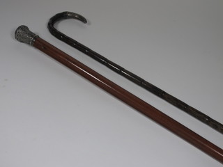 A Malacca walking cane with silver handle and a bamboo  walking stick with silver terminal