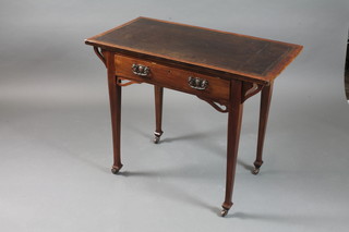 An English Art Nouveau walnut writing table, having tooled  brown leather skiver to top, fitted frieze drawer and raised on  square tapered legs and casters 29.5"h x 36"w x 19"d