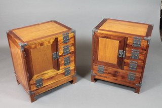 A pair of military style hardwood low cabinets, iron bound, fitted  with an arrangement of 4 drawers and a cupboard door on shaped  feet 25"h x 22"w x 17"d