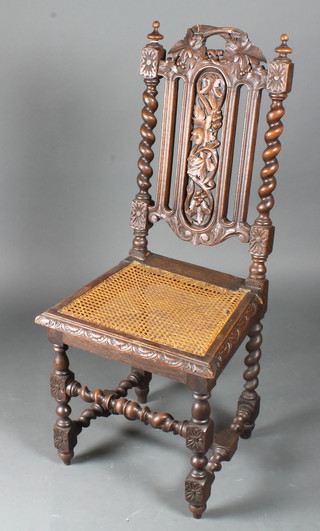 A Victorian carved oak hall chair with pierced back and cane  seat, raised on turned and block supports with H framed stretcher