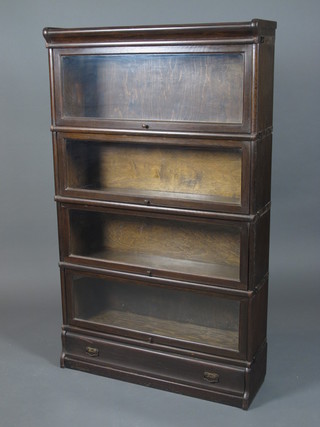 An oak Globe Wernicke style 4 section library bookcase with  glazed fall front doors above a single drawer on plinth base  57.5"h x 35"w x 11"d