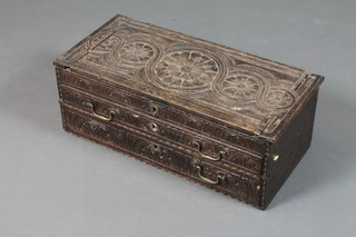 An early 18th Century and later small oak table top chest with foliate and lunette carved decoration, having a hinged top above  2 graduated long drawers 9"h x 24"w x 11.5"d