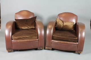 A pair of 1930's cloud style open arm chairs with brown  leatherette upholstery and fitted dralon cushions, raised on block  feet