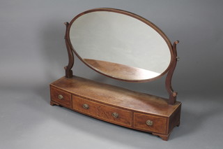 A George III fiddle back mahogany dressing table mirror having  an oval plate, fitted 3 short drawers, raised on shaped bracket  feet 29"h x 36"w x 10.5"d