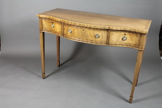 A George III style mahogany serpentine side table, crossbanded  and fitted 3 frieze drawers raised on square tapered legs with  spade feet 34"h x 48"w x 22"d