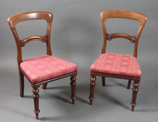 A set of 6 Victorian walnut dining chairs with foliate carved cresting rails, foliate damask upholstered seats on turned tapered  legs with peg feet