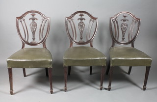 A set of 4 late Victorian mahogany dining chairs in the Sheraton  style, the shield backs centred with vase splats above stuff-over  seats on square tapered legs, spade feet, 1 chair af,